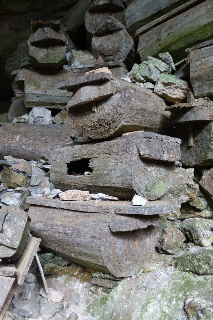 Coffins stacked in the entrance to the cave system.