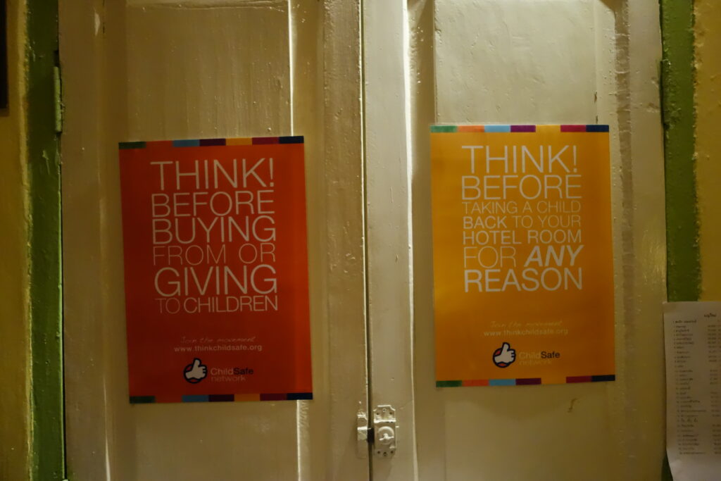 Posters advising not to give money to or buy from children at Makphet restaurant in Vientiane.