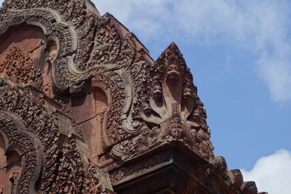 A Nāga sits atop a structure at Banteay Srei.