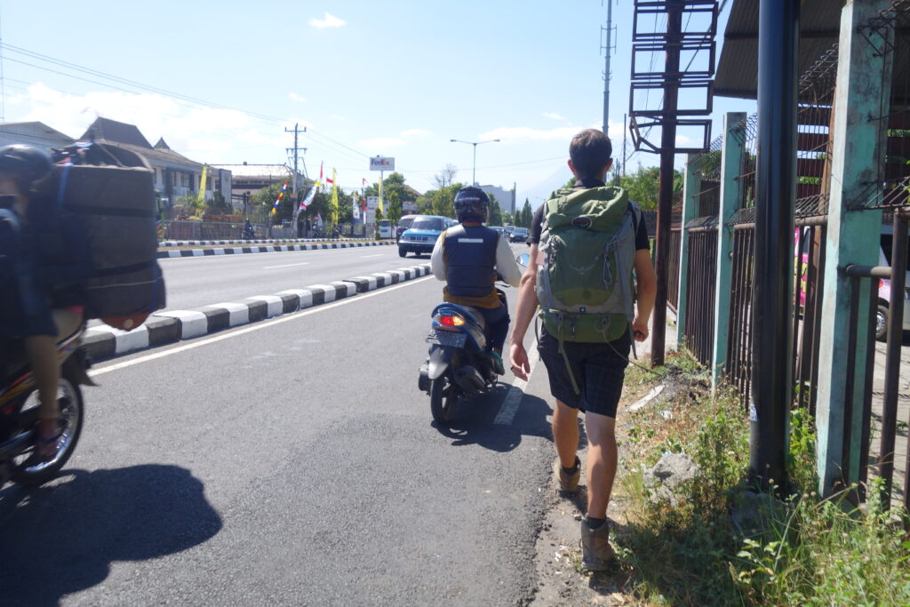Walking along the side of the road in Jogjakarta because there is no sidewalk.